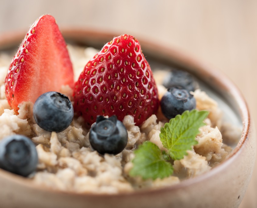 Traditional oatmeal bowl topped with strawberries and blueberries